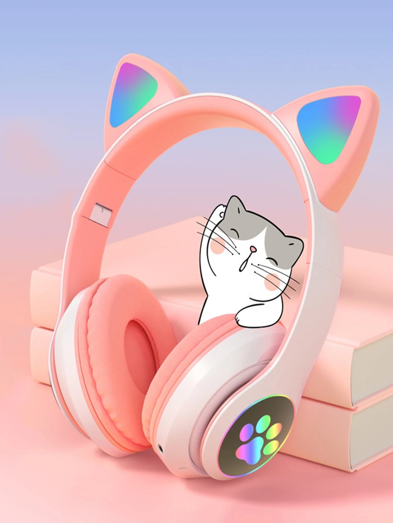 Pink cat ear headphones with a cartoon cat face on a pink background