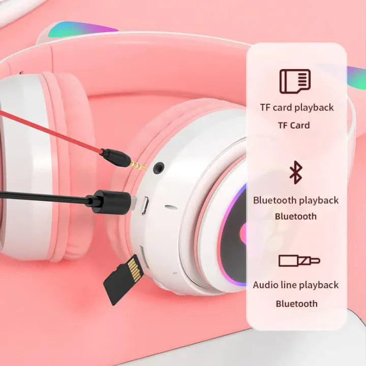 Pink and white headphones with a TF card and Bluetooth playback options on a pink background